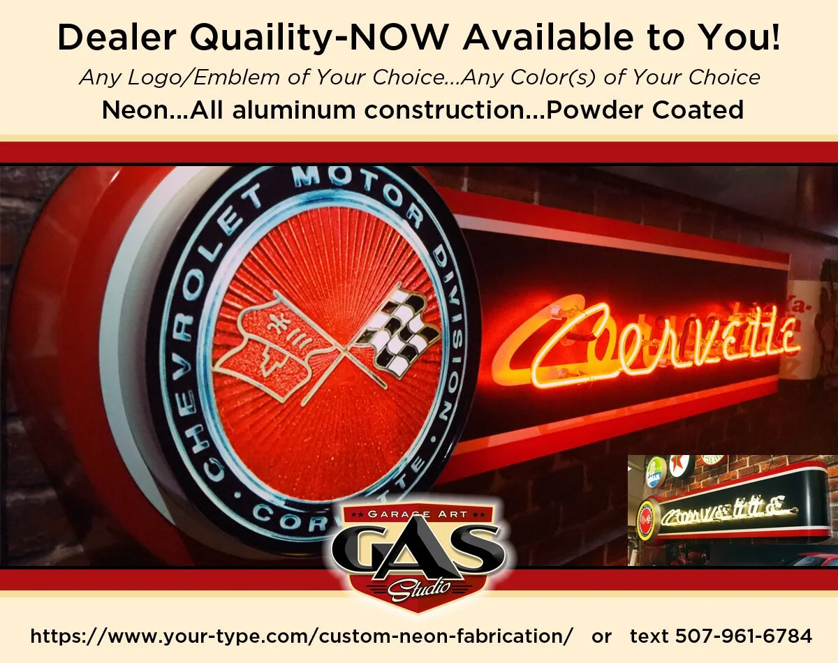 Neon sign that reads 'Corvette' in cursive letters, mounted on a brick wall, with a smaller attached sign featuring the Chevrolet Corvette emblem and text in an advertisement for custom neon fabrications.