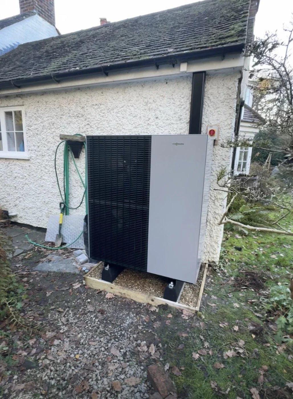 an outdoor unit for an air source heat pump system, a cottage in the surrey hills, all run open loop