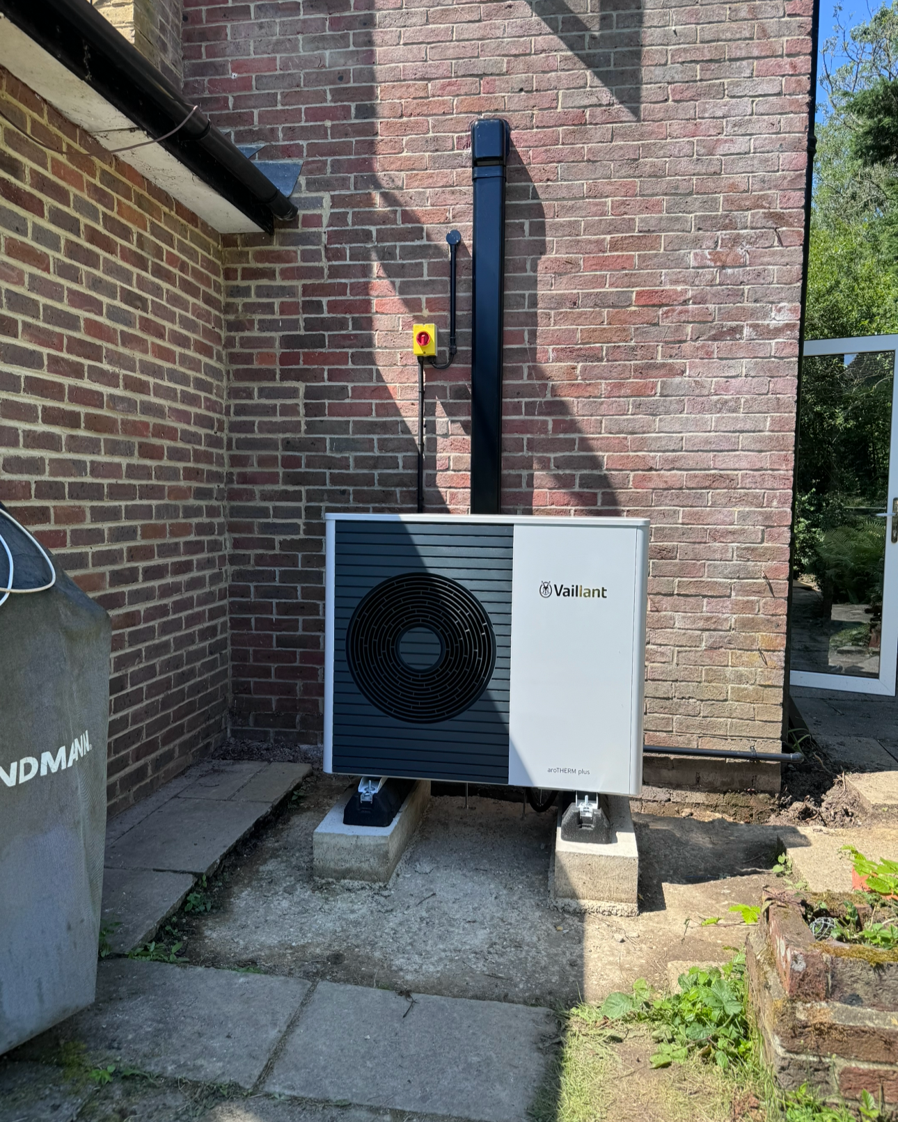 outdoor air source heat pump system , vaillant arotherm plus, trunking and a rotary isolator