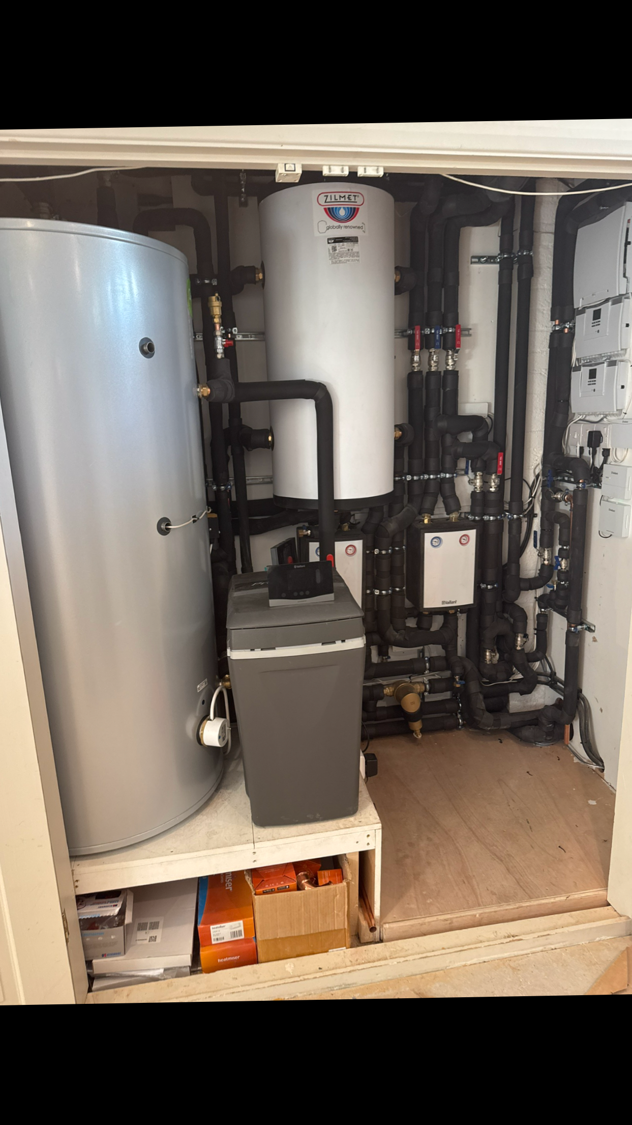 Plant room with domestic hot water cylinder, water softner, buffer, and renewable heating.