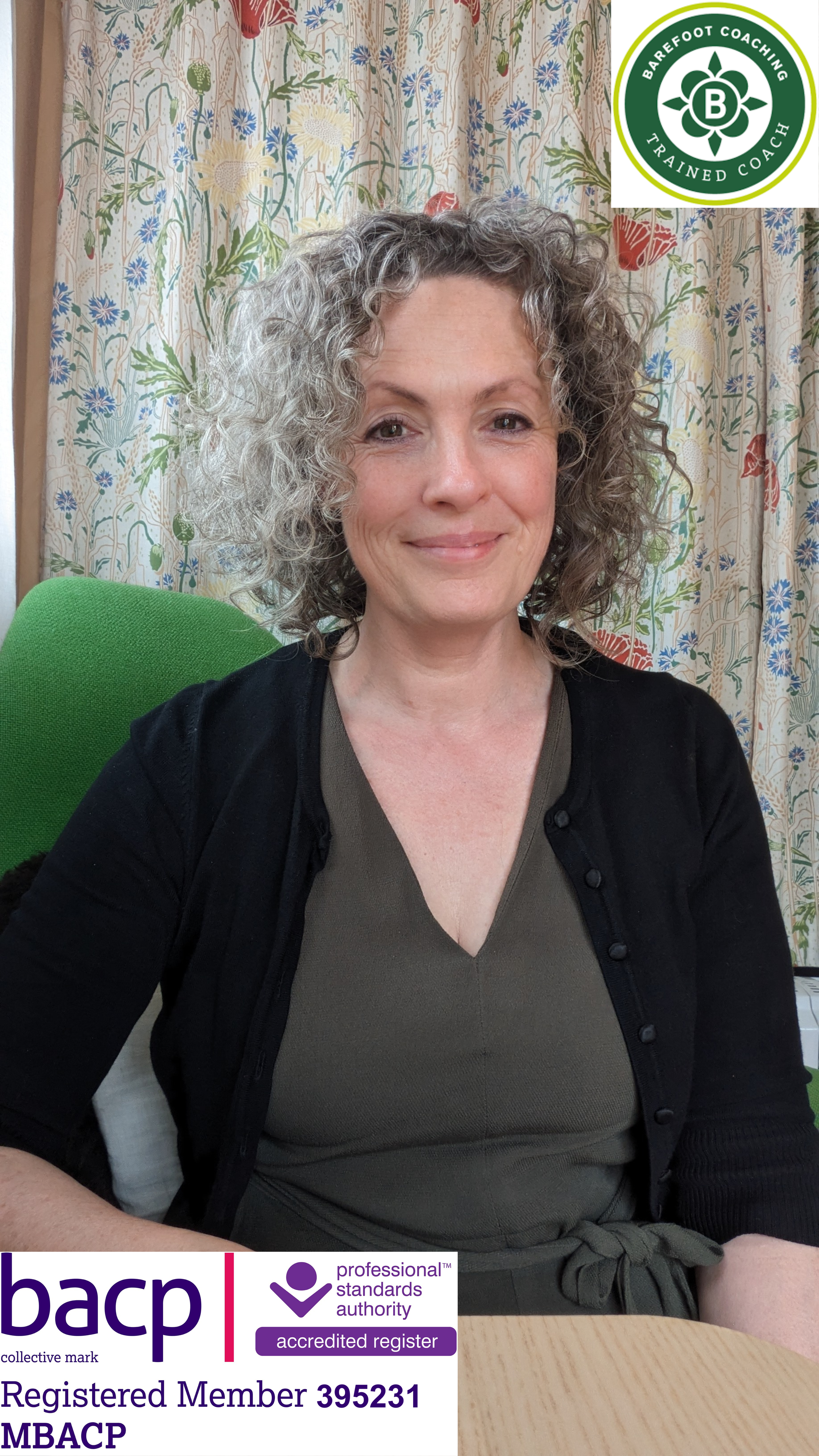 A woman with curly gray hair sitting at a table, smiling, with a colorful floral curtain in the background. There is a green office chair, and logos and membership information from the BACP and related accrediting organizations displayed at the bottom right corner of the image.