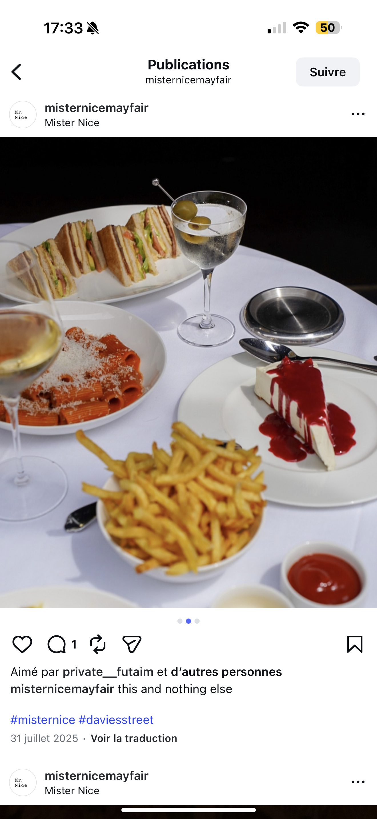 Table with assorted foods: sandwiches, a glass of champagne with olives, pasta with grated cheese, cheesecake with berry sauce, French fries, and small dishes of ketchup and mayonnaise.