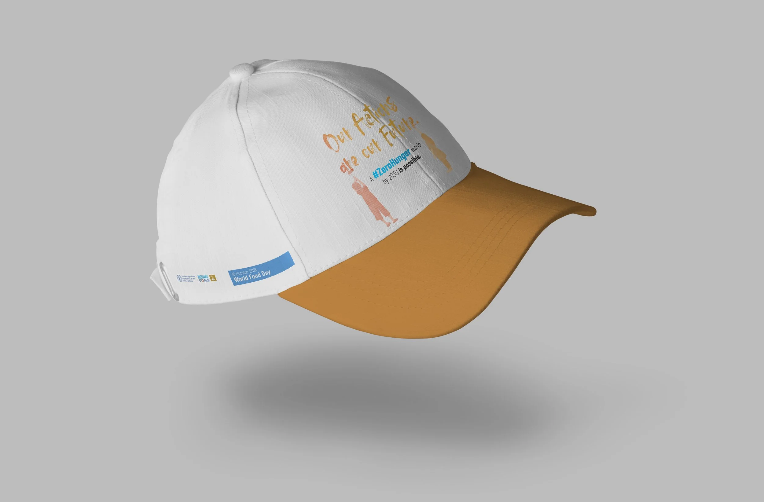 White and orange baseball cap with printed message about sustainability and a blue sticker for World Food Day.
