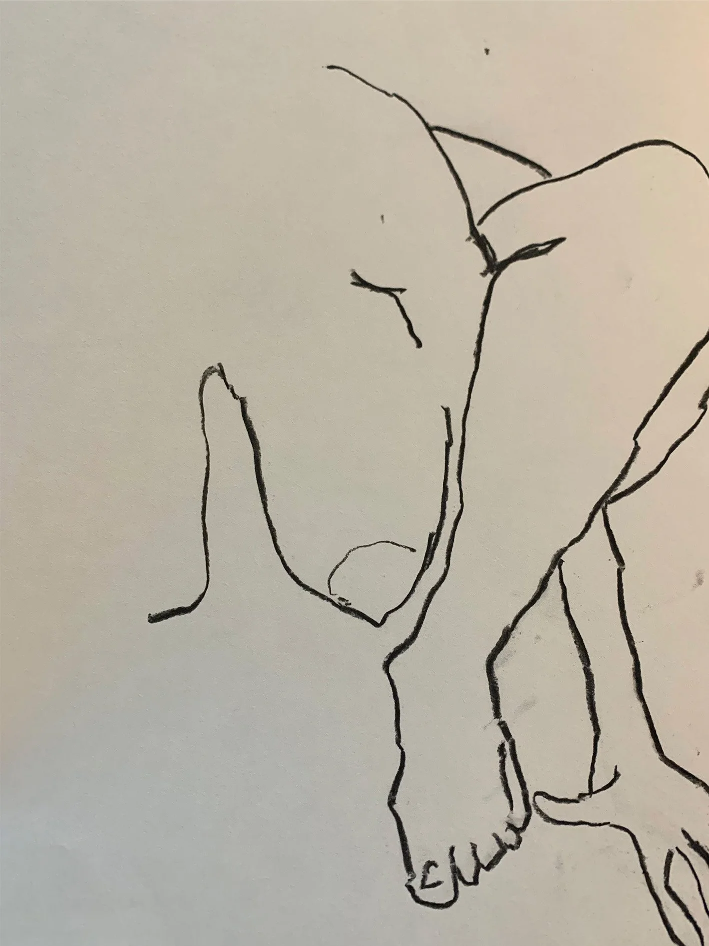A simple black line drawing of one half of a woman's body crouched on the ground. Her arm is intertwined with her leg.