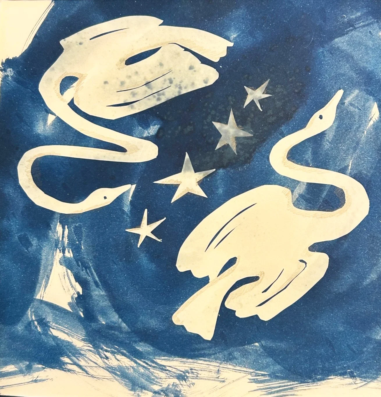 cyanotype print hand cut shapes two swans and stars