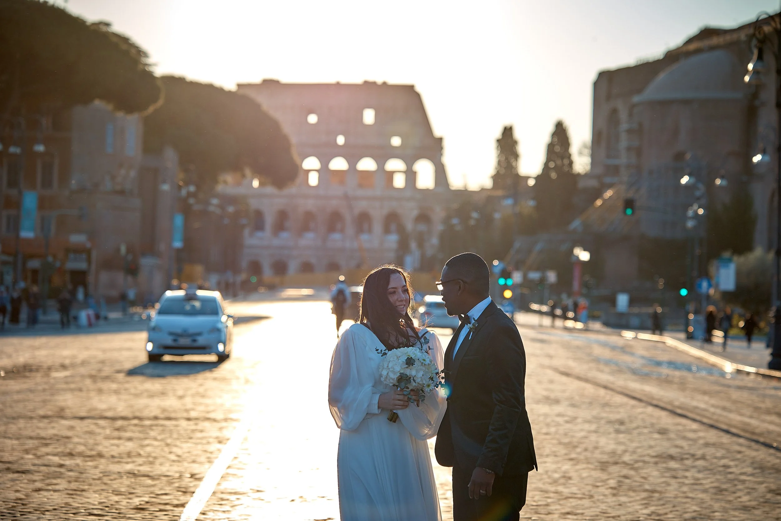 Couple at sunset by the Colosseum on their Rome elopement — Rome Luxury Elopements
