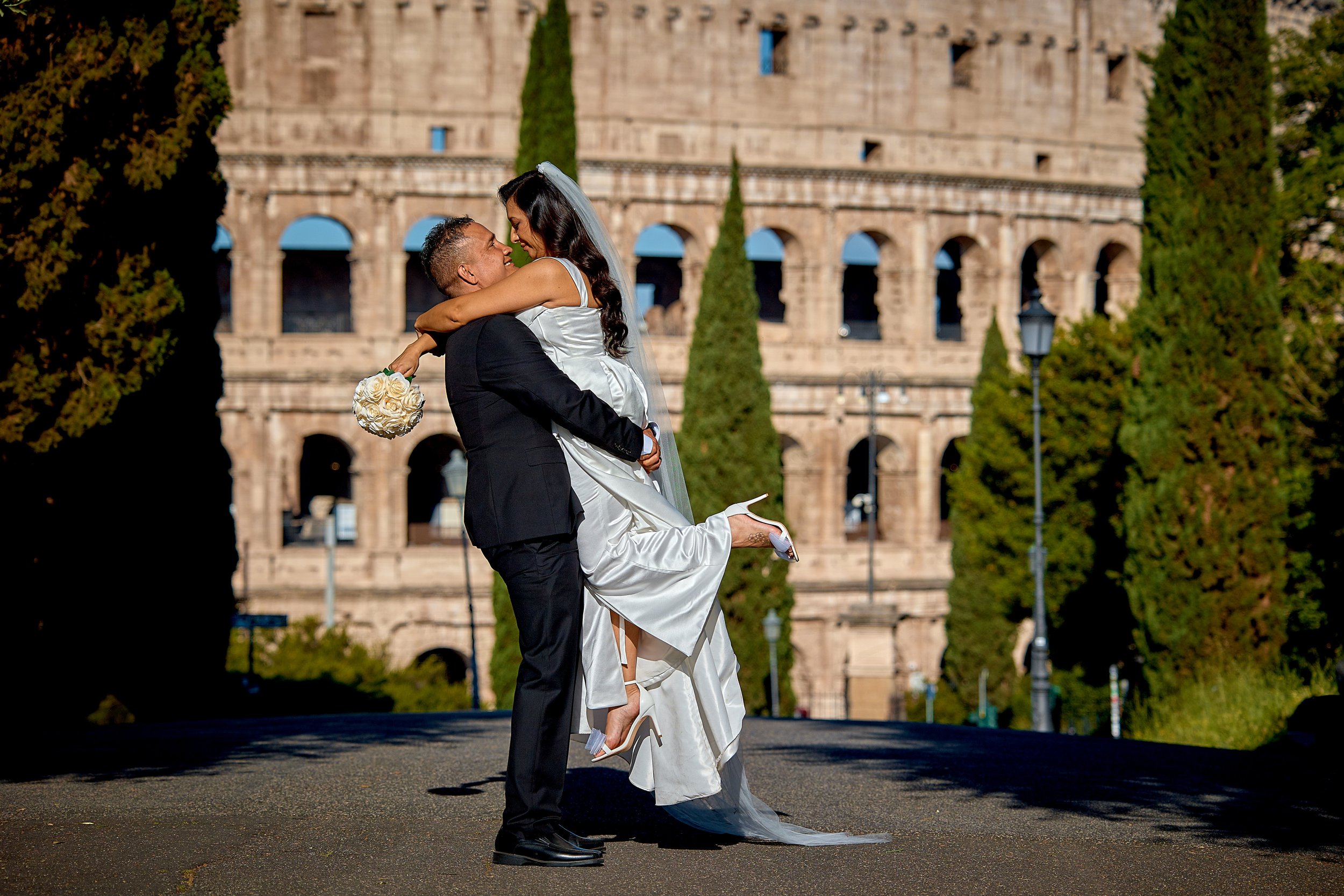 Couple celebrating their elopement before the Colosseum — Rome Luxury Elopements