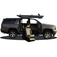 A black SUV with its doors open, showing an open rear door with a seat folded down and a moveable ramp on the roof for accessibility.