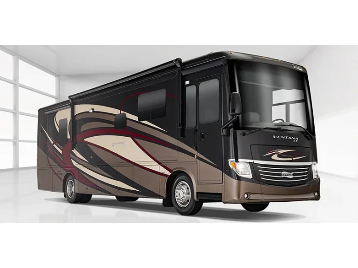 A black and brown Class A motorhome with beige and red accents parked inside a bright, empty room.