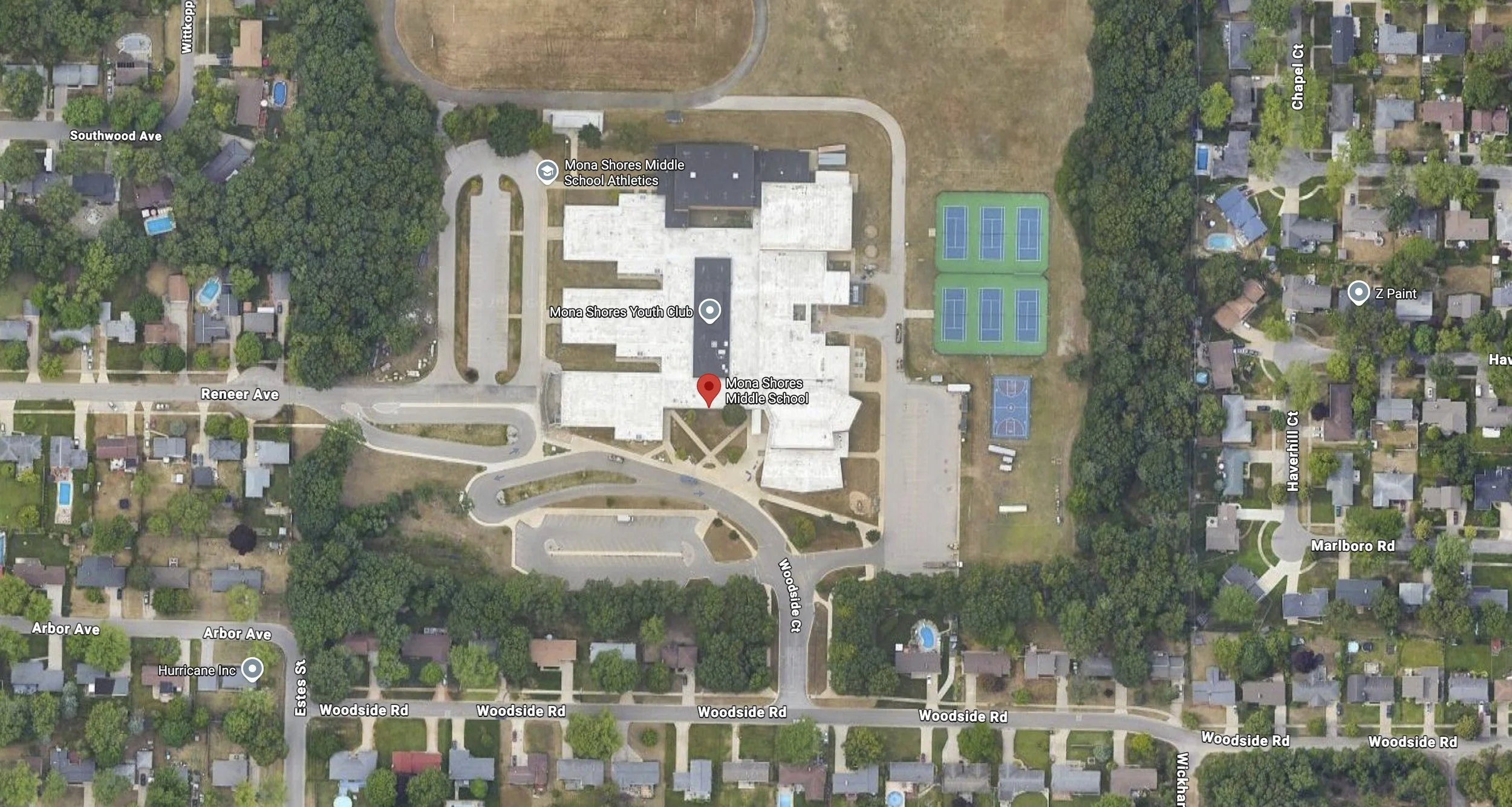 Aerial view of Mona Shores Middle School and surrounding neighborhood, showing tennis courts, playgrounds, houses, and streets with labeled names.