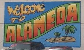 Colorful mural with the words 'Welcome to Alameda' and a small island with palm trees.