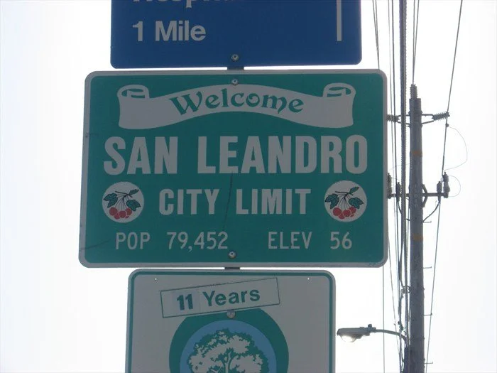 Welcome to San Leandro city limit sign, population 79,452, elevation 56 feet, with a smaller sign indicating 11 years.