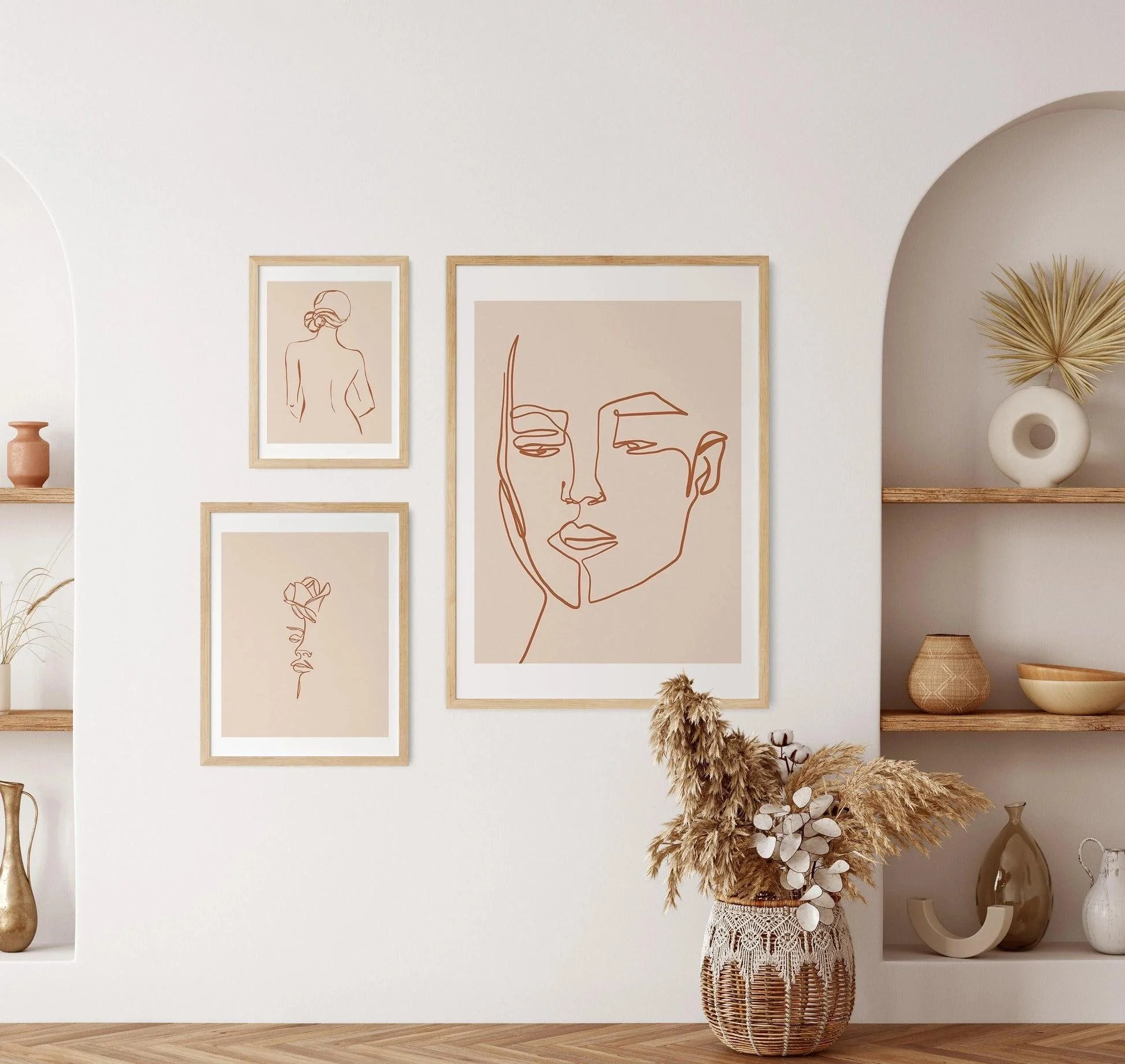 Decorative interior with framed minimalist artwork, dried plants, ceramic vases, and neutral-toned decor creating a calm and welcoming atmosphere.