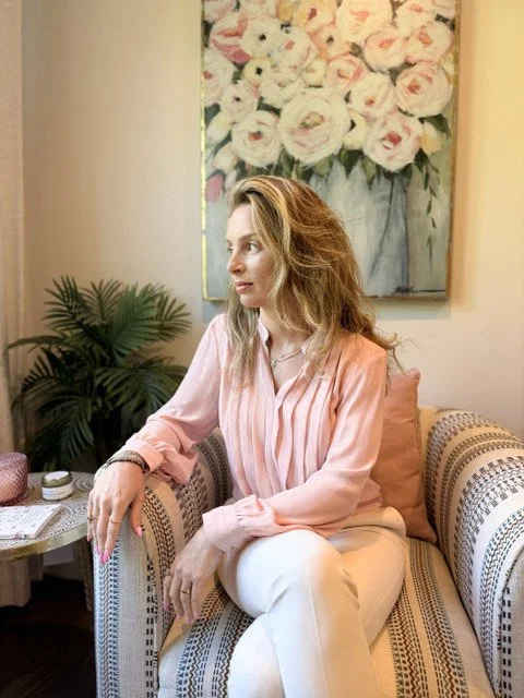 Hilla Flohr sitting in a warm, welcoming space