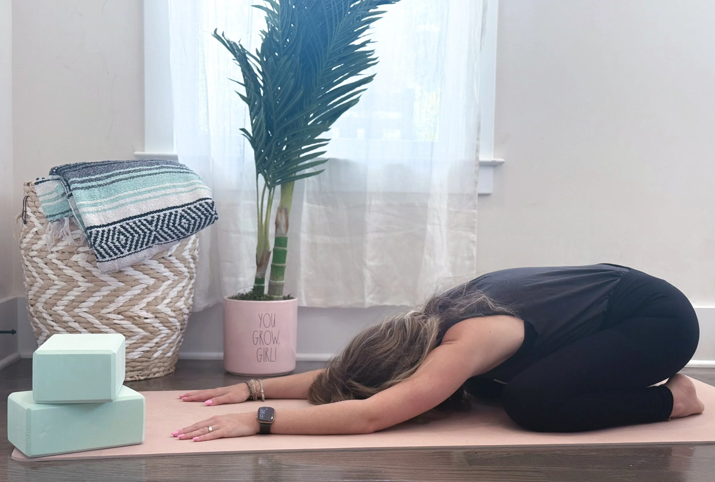 Woman practicing trauma-informed Yin yoga in a calm, grounding space