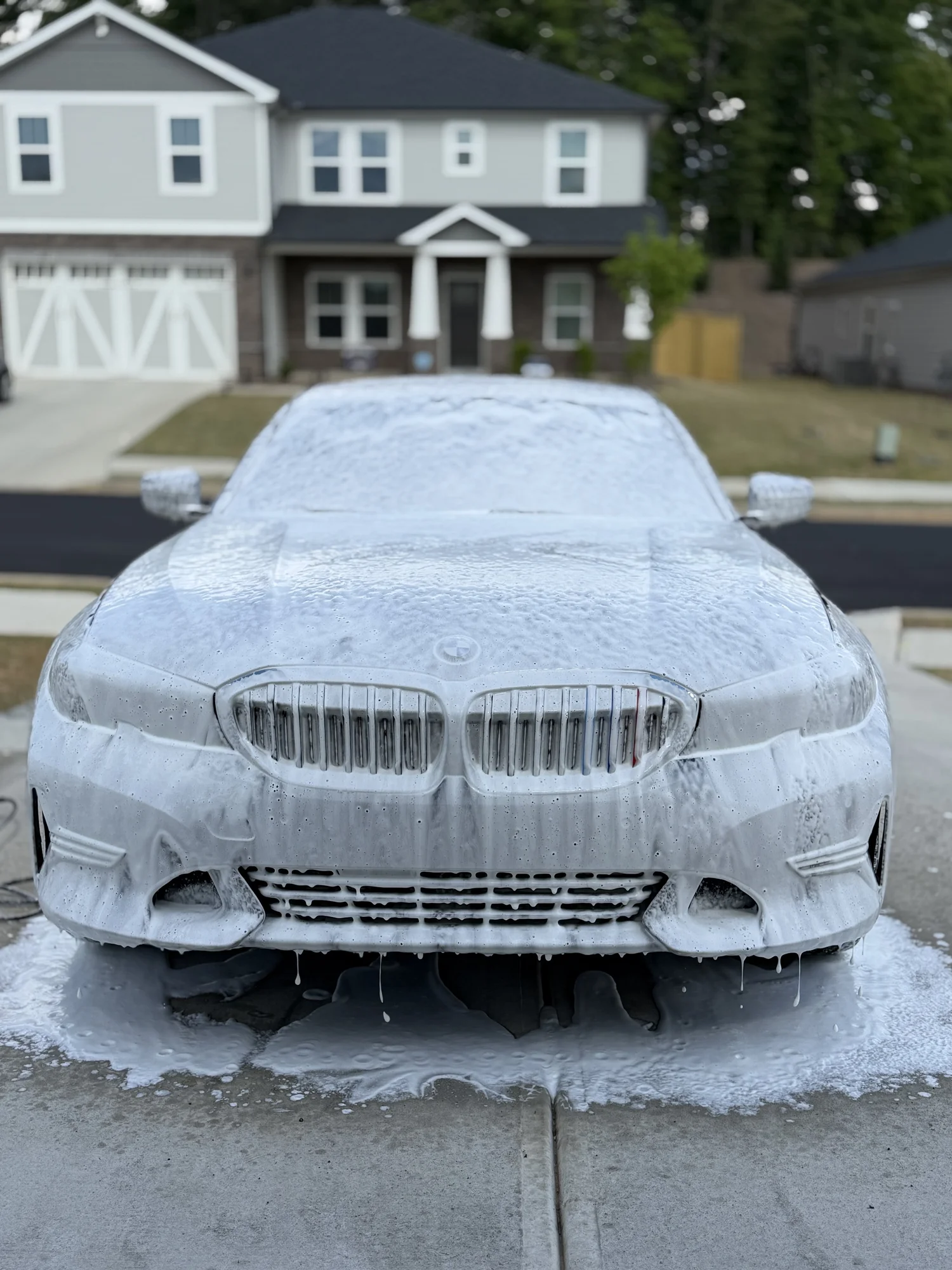 Blue BMW 3 Series during the foam pre-wash