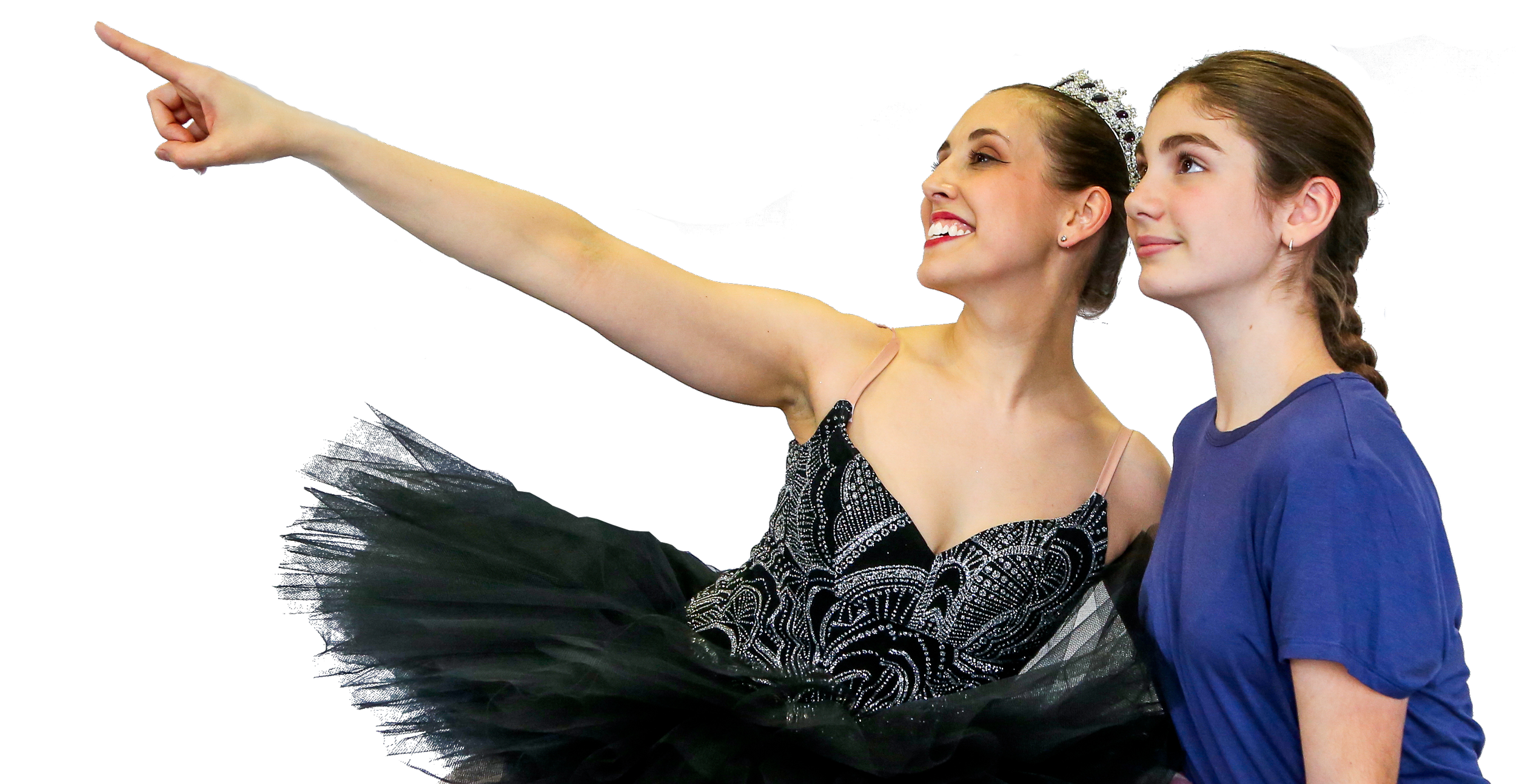 A young girl in a black tutu and a woman in a tiara and dance costume smiling and pointing to the side while looking in that direction.
