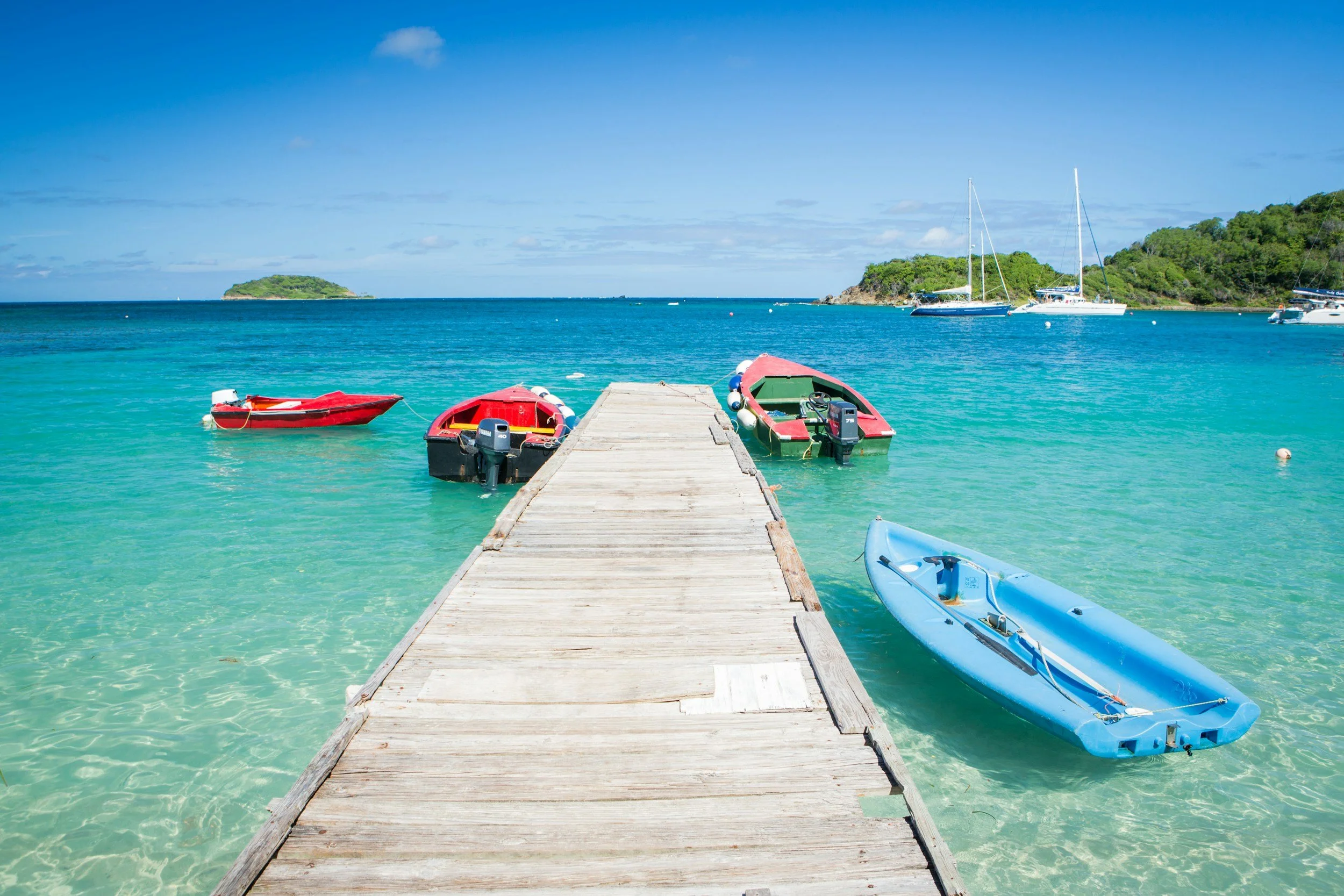 Boats tied to a pier in shallow water