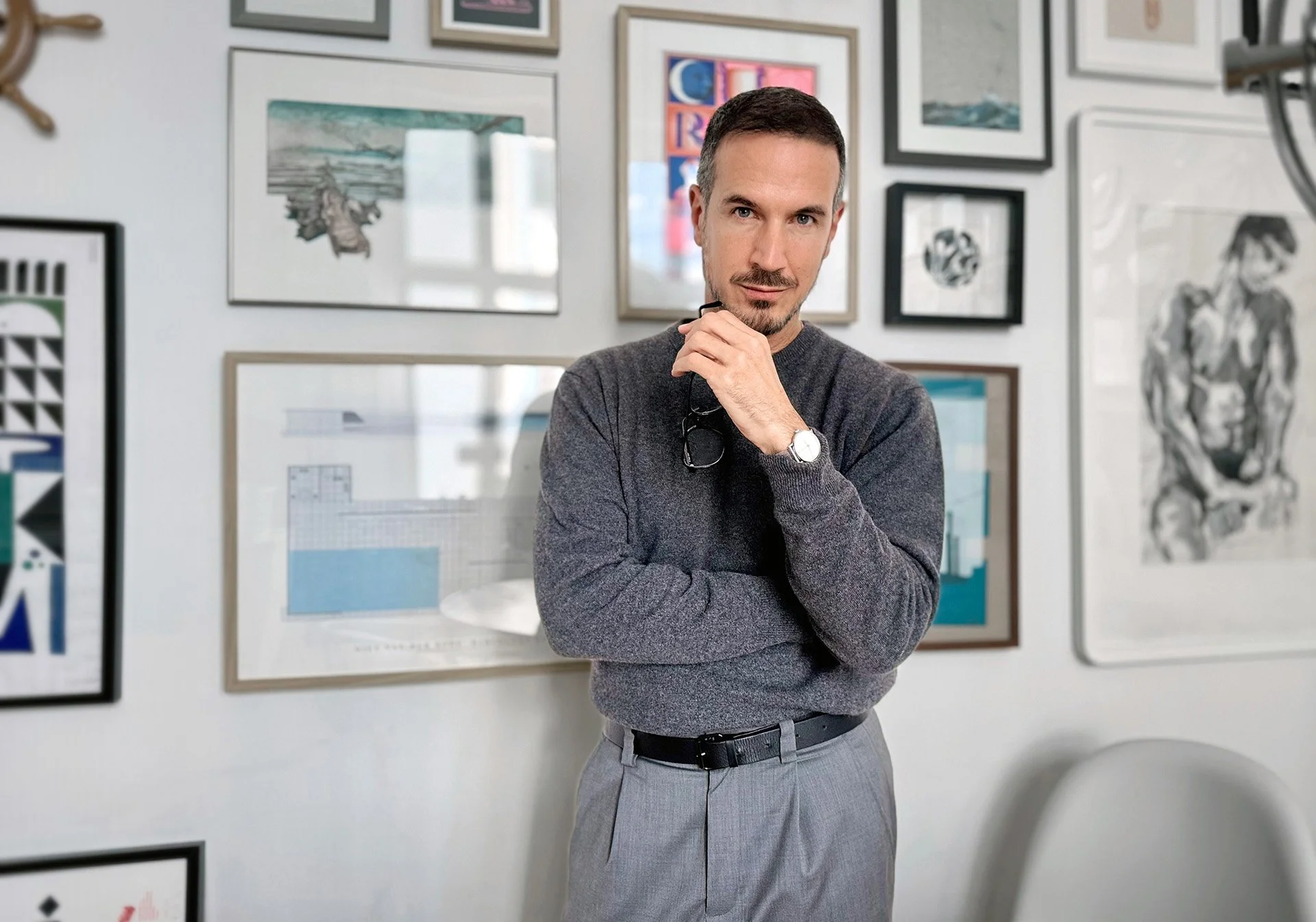 Portrait of Robert Schaefer, Strategic Creative Director and Brand Creator, in front of his gallery wall in Berlin