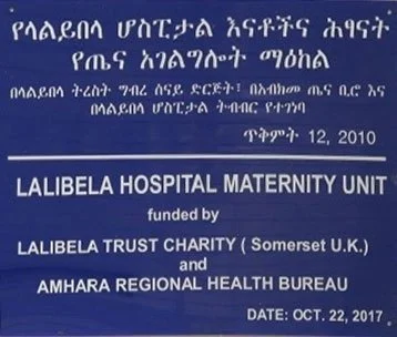 A sign for Lalibela Hospital Maternity Unit, funded by Lalibela Trust Charity and Amhara Regional Health Bureau. The sign has text in both Amharic and English, with dates of December 12, 2010, and October 22, 2017.