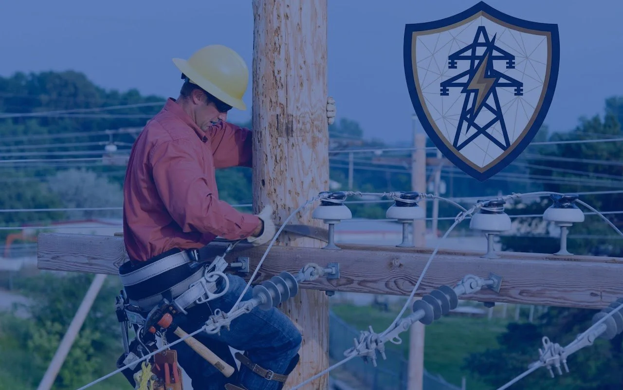 A lineman wearing a yellow hard hat and safety harness working on electrical wiring on a wooden utility pole, with power lines and trees in the background and a shield logo with an electrical tower and lightning bolt.