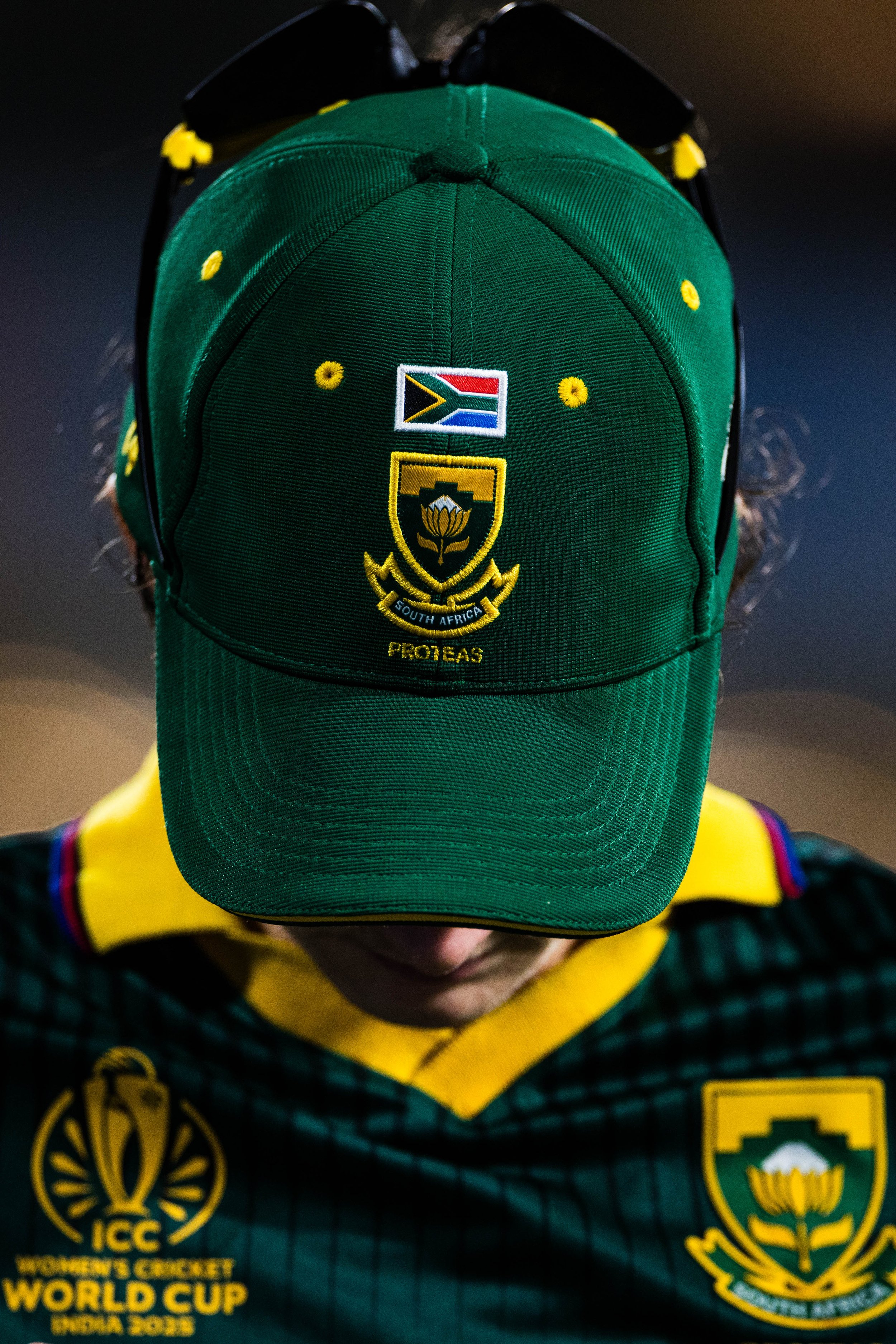 Child wearing a green cap with South African cricket team emblem and an ICC Men's Cricket World Cup 2023 badge, also dressed in South African cricket jersey.