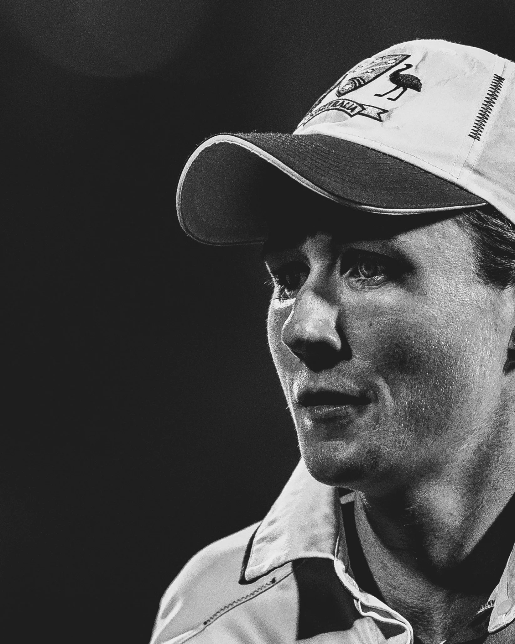 Close-up black and white photo of a woman wearing a cap and uniform, looking to the side with a serious expression.