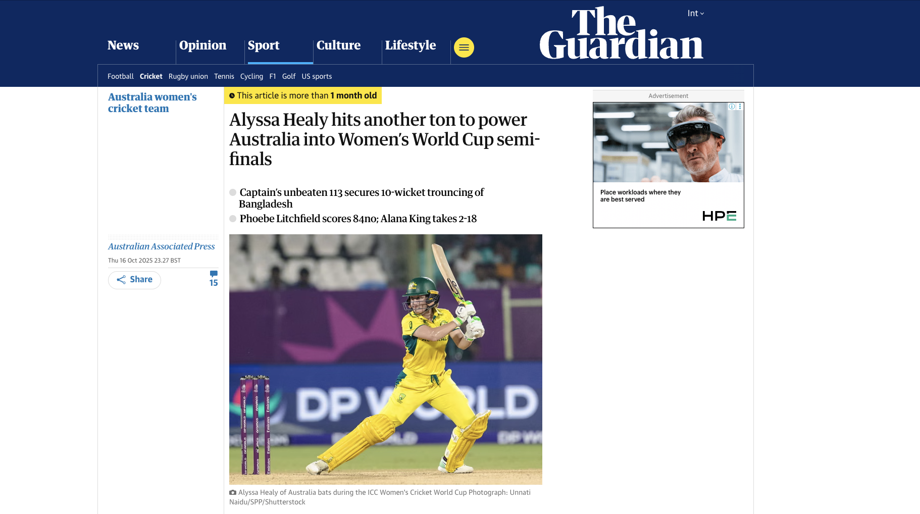 Australian cricket player Alyssa Healy batting during a match in a yellow uniform with a helmet, on a cricket field.