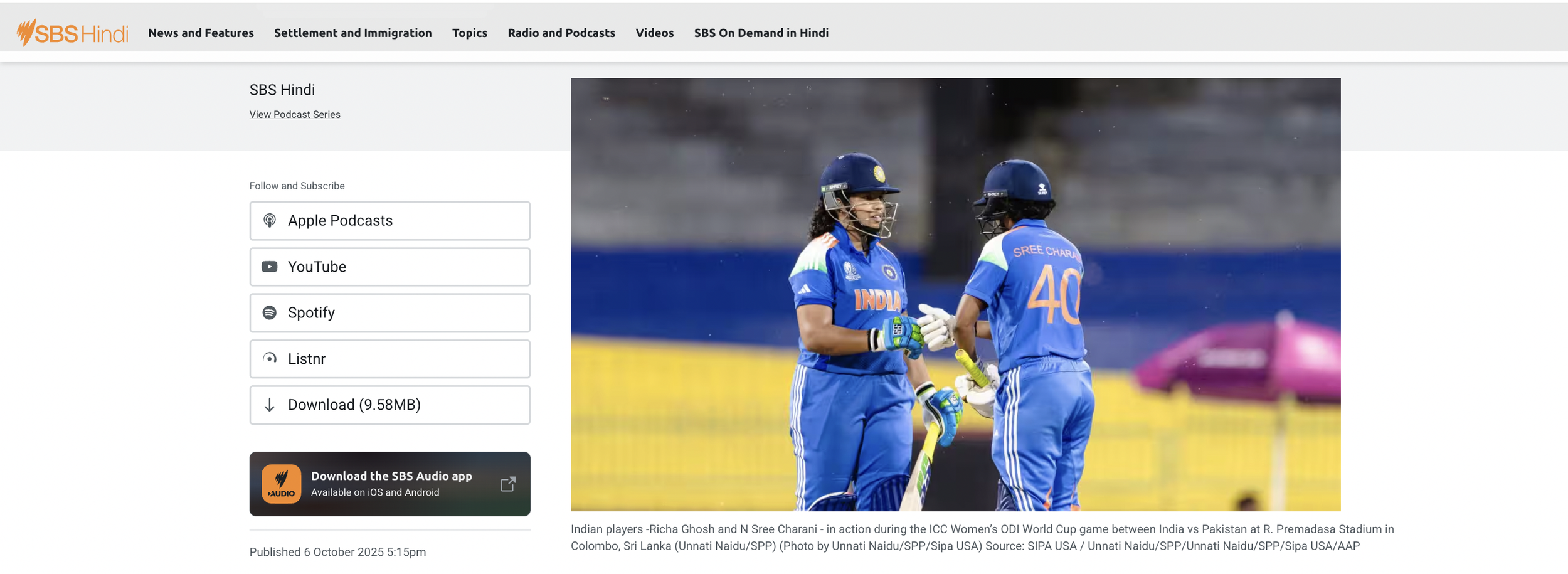 Two Indian women cricket players celebrating during a match, wearing blue uniforms and helmets.