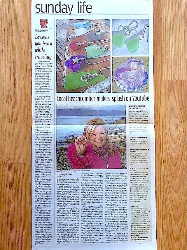 St. Augustine Record newspaper column about a local beachcomber artist, with photos of colorful sea glass jewelry and a smiling Aimee Wiles Banion at a WA state beach.
