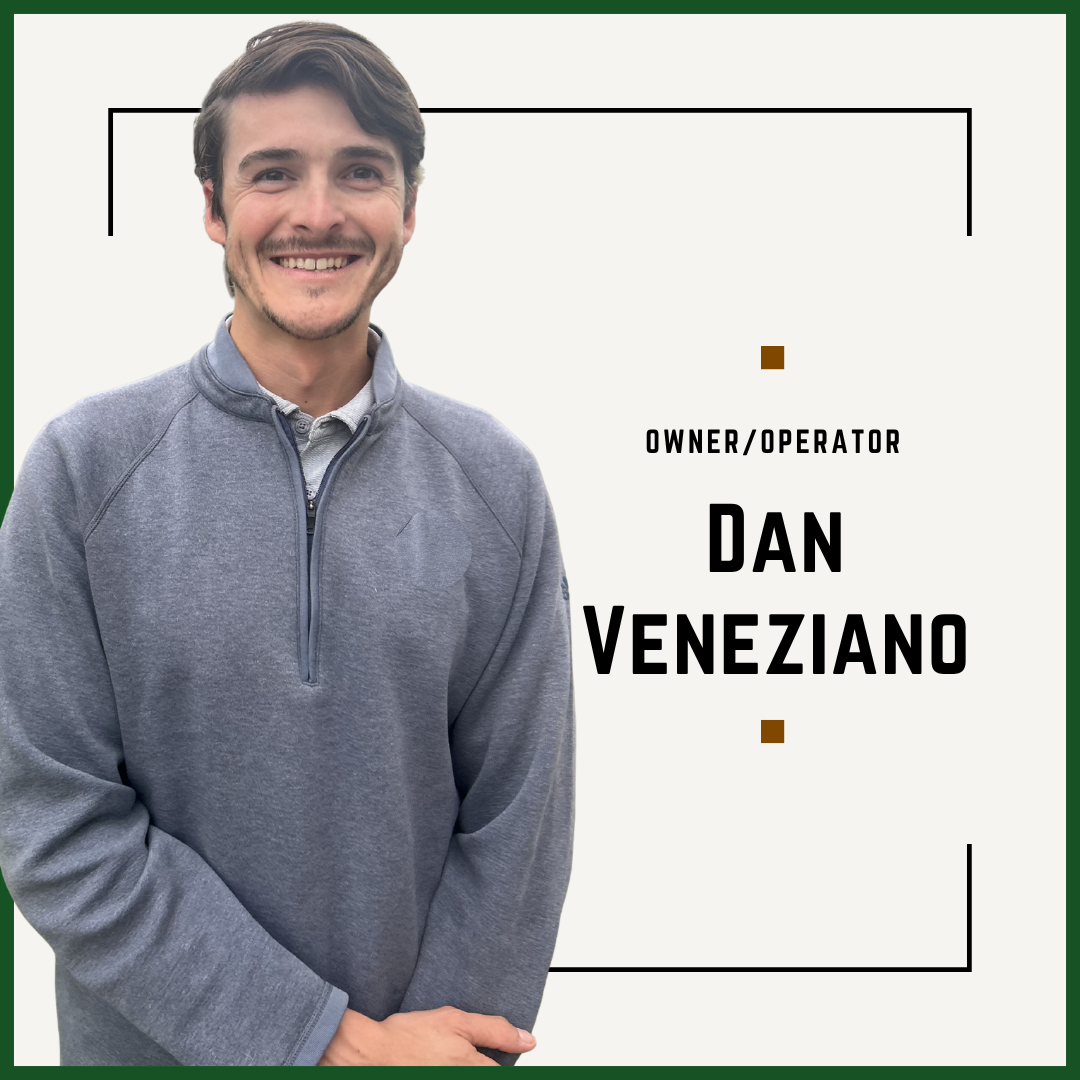 A man with brown hair and a beard, smiling, wearing a gray quarter-zip pullover, stands against a plain background with a graphic design that includes black lines and small brown squares, along with text that reads "Owner/Operator Dan Veneziano."