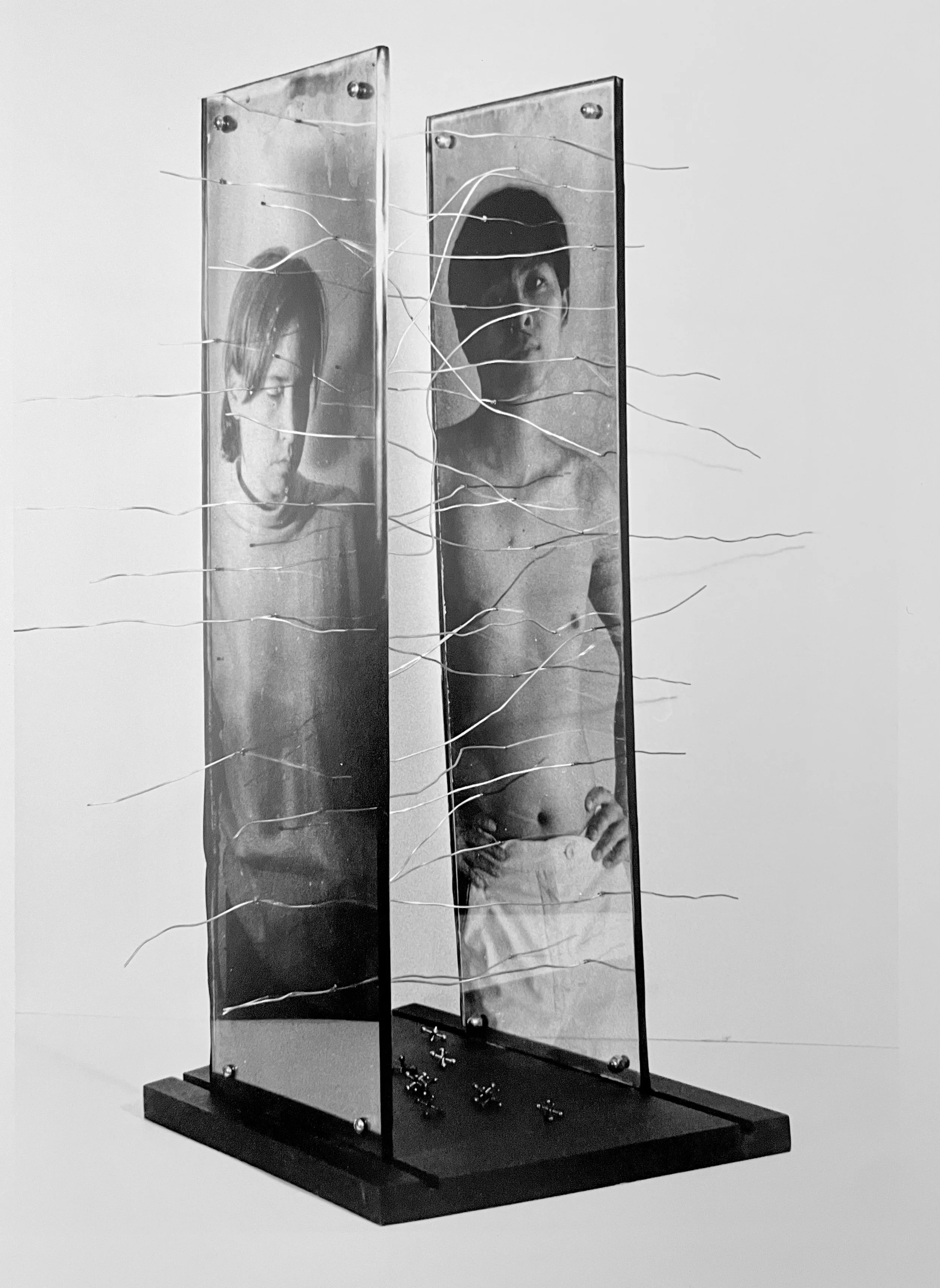 Black and white mirror art installation of a person taking a selfie, with outer space theme and squiggly wires across the frame, by artist, Karen Serago.