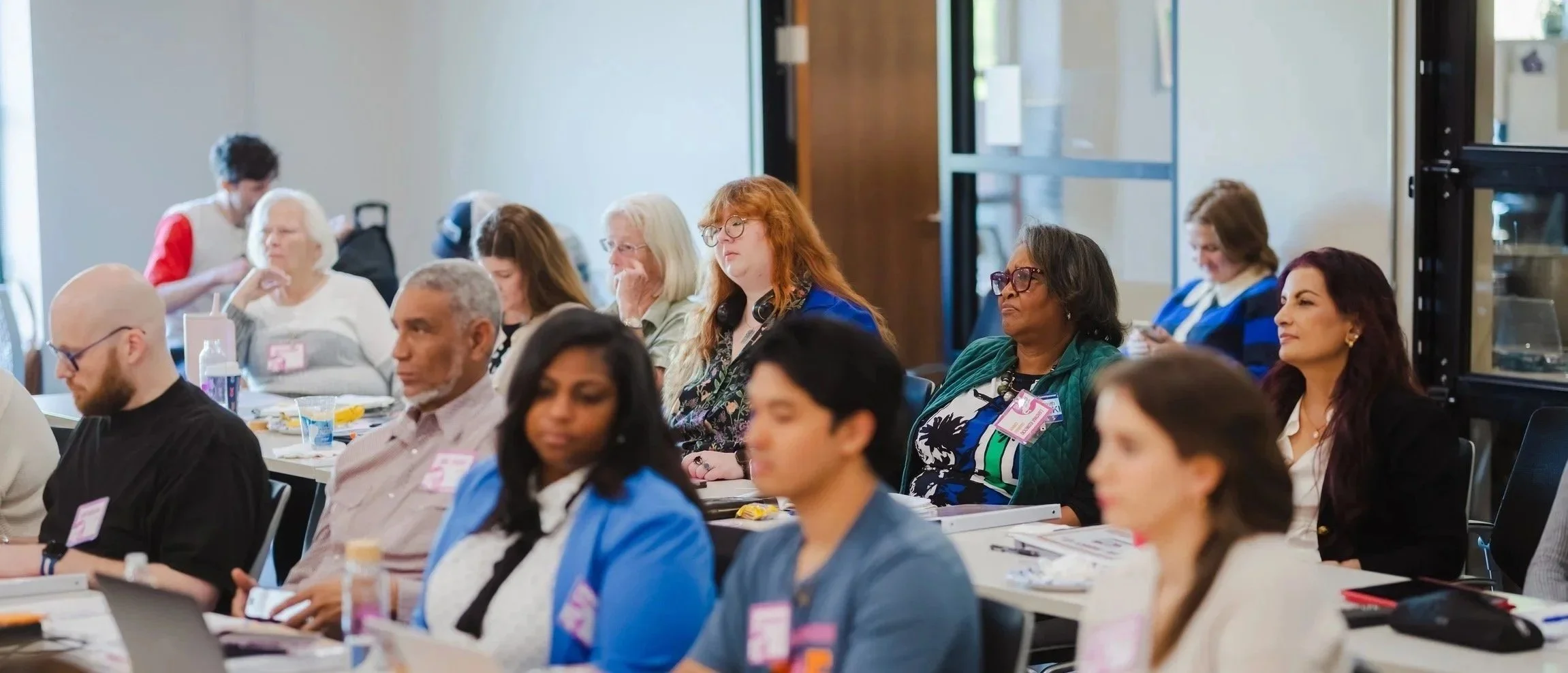 A group of diverse people in a training session about gerrymandering and how the maps are drawn
