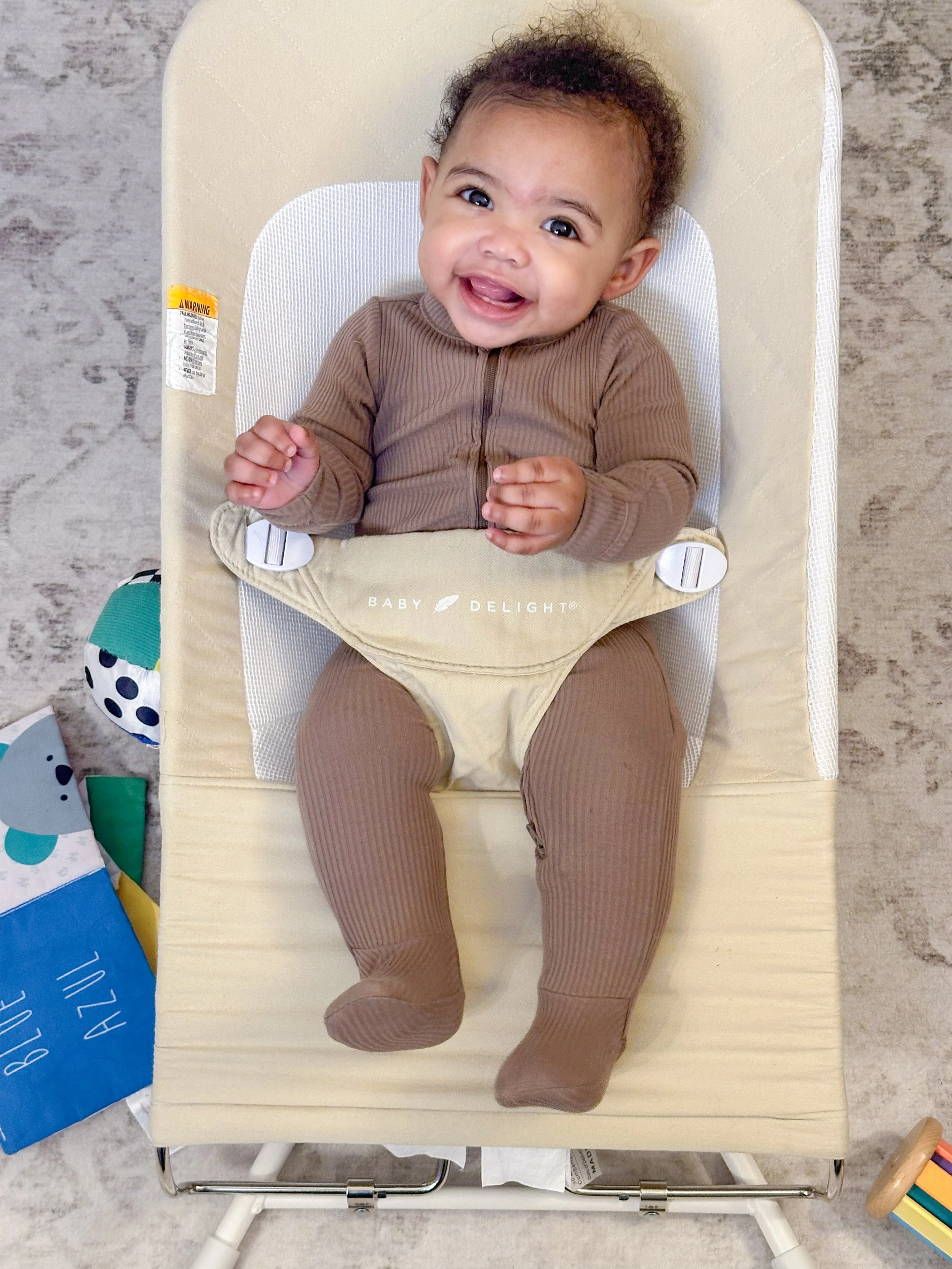 Image of Gianna Arriaga (9 months old) on 3.22.26 promoting a Baby Delight bouncer as part of a photo assignment at Penn State Unversity.