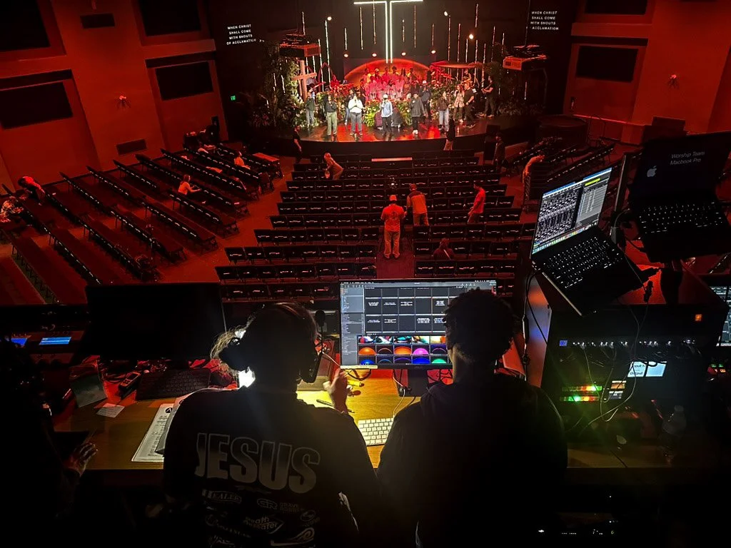 Taken 4.1.26, the Nest team practices lighting and worship sets as other church volunteers prep the sanctuary seats and floor. 