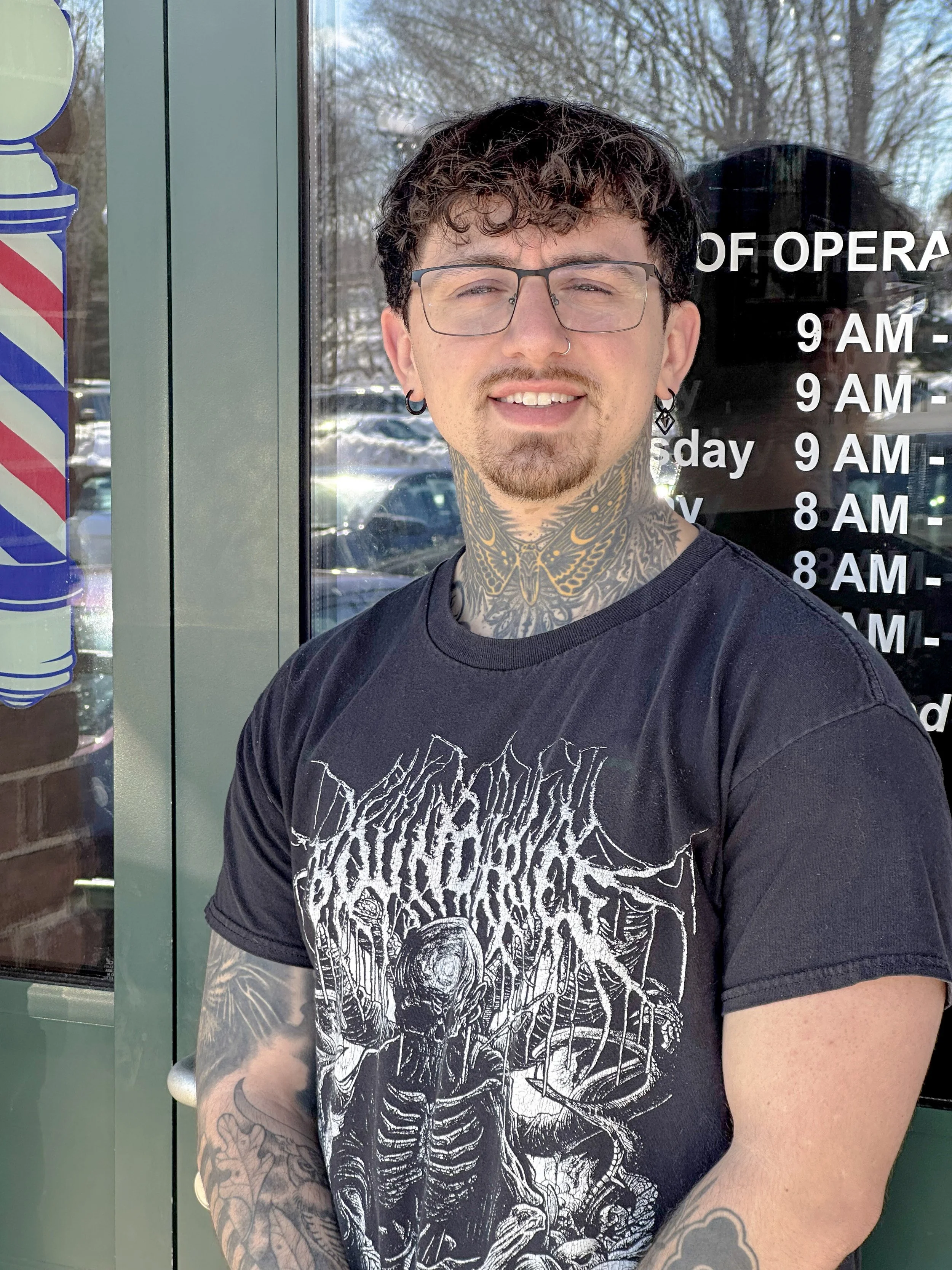 Photo of Hunter Massery on 2.27.2026, who is a local barber, posing for a portrait assignment outside his workplace. Hunter is an artist, choosing hairstyling as a way to connect with others and as one of his outlets.