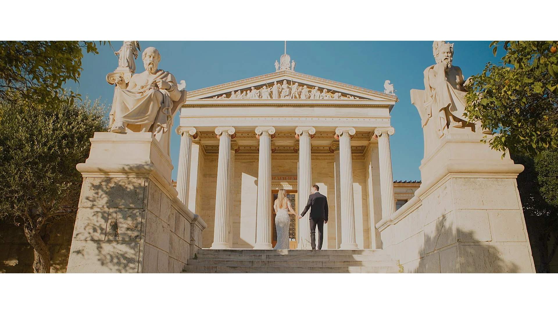 Newlywed couple walking together during their wedding day in Greece