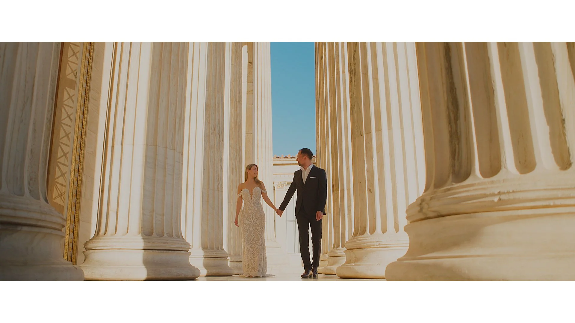 Newlywed couple walking together during their wedding day in Greece