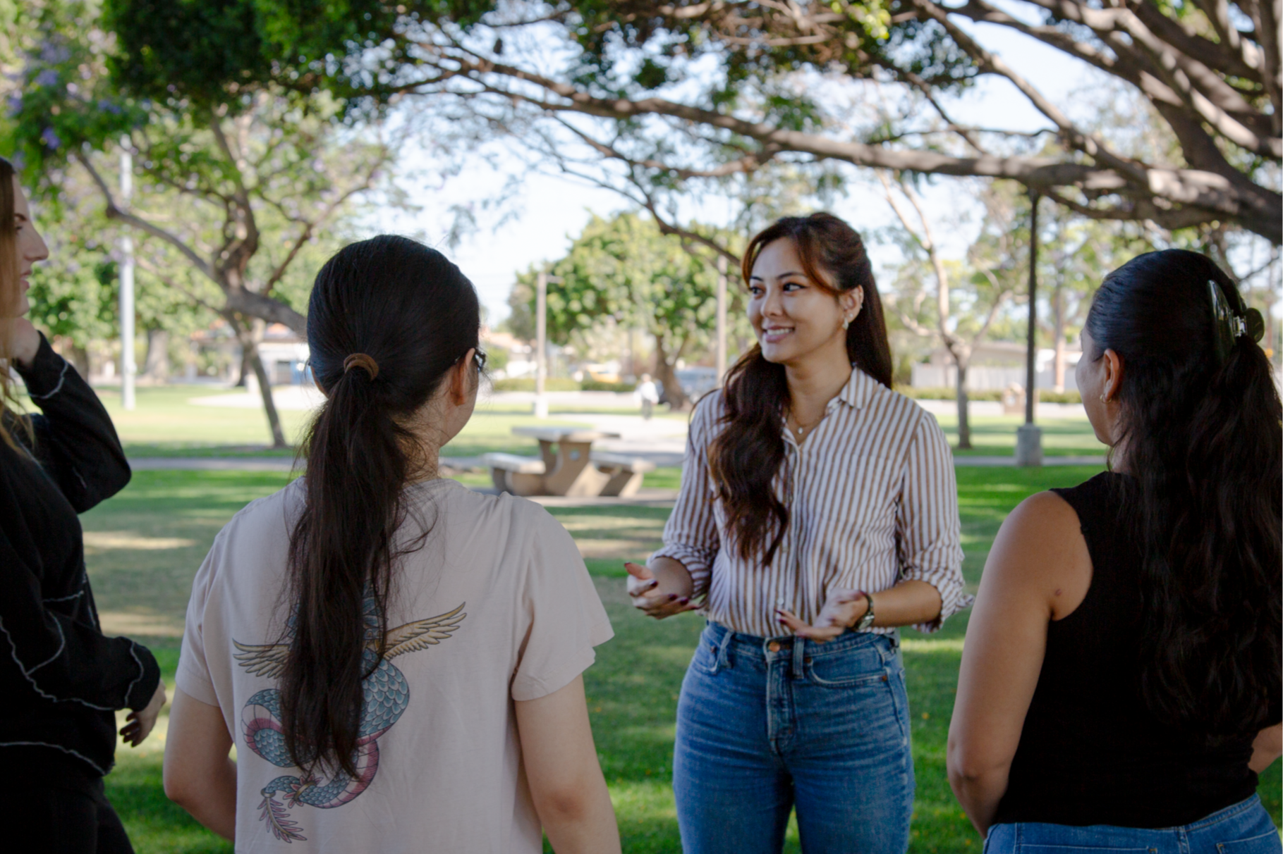 Tracy La speaks to community supporters at a local park.