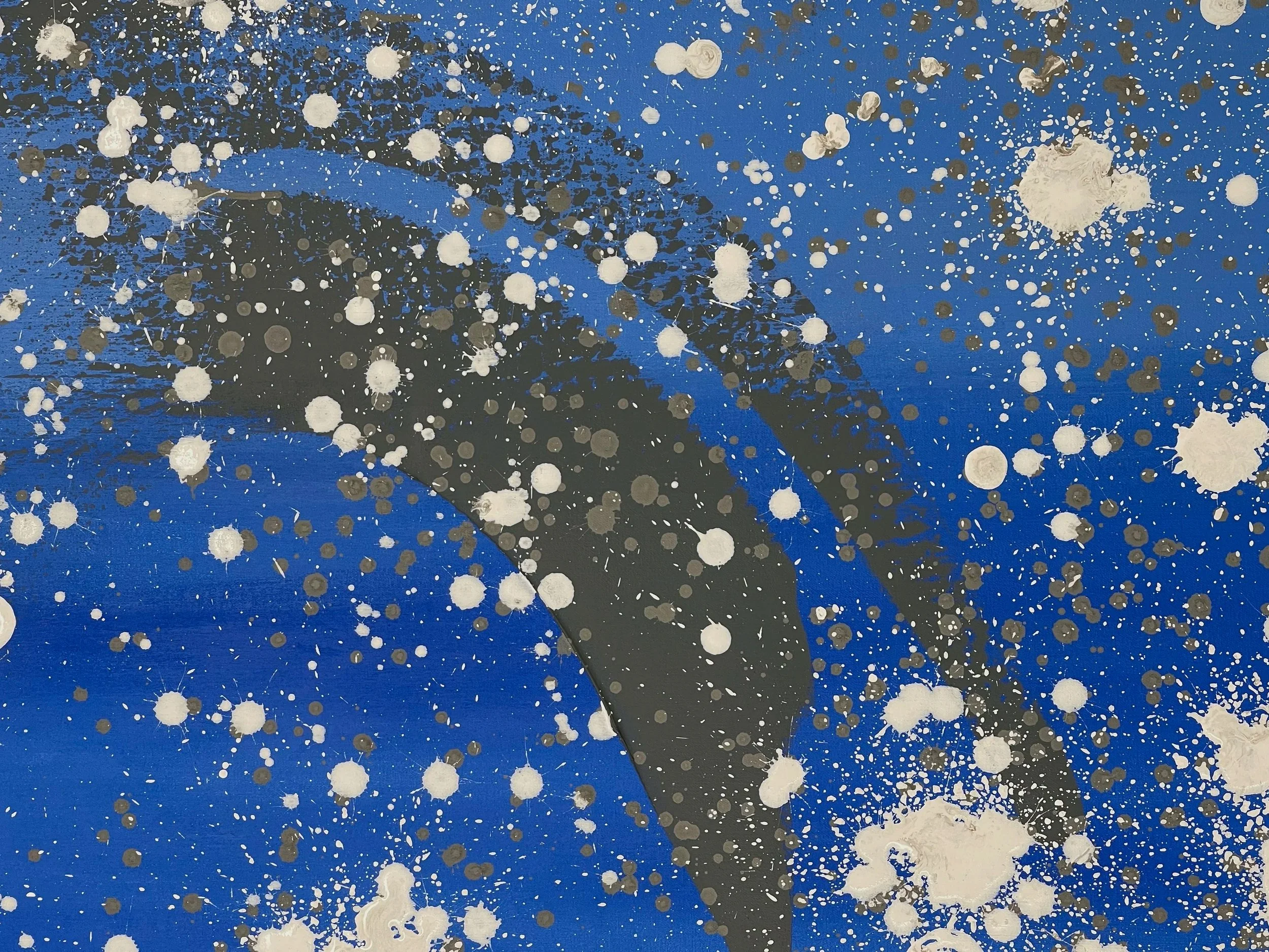 Abstract painting featuring a navy blue background with white, black, and gray paint splatters and drips.