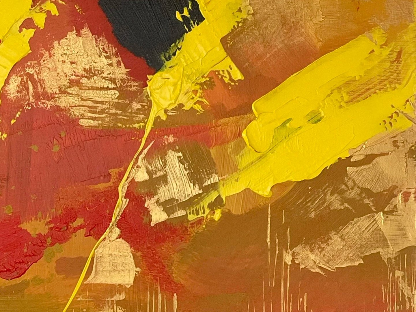 Close-up of an abstract painting with bold red, yellow, black, white, and beige brushstrokes layered on canvas.