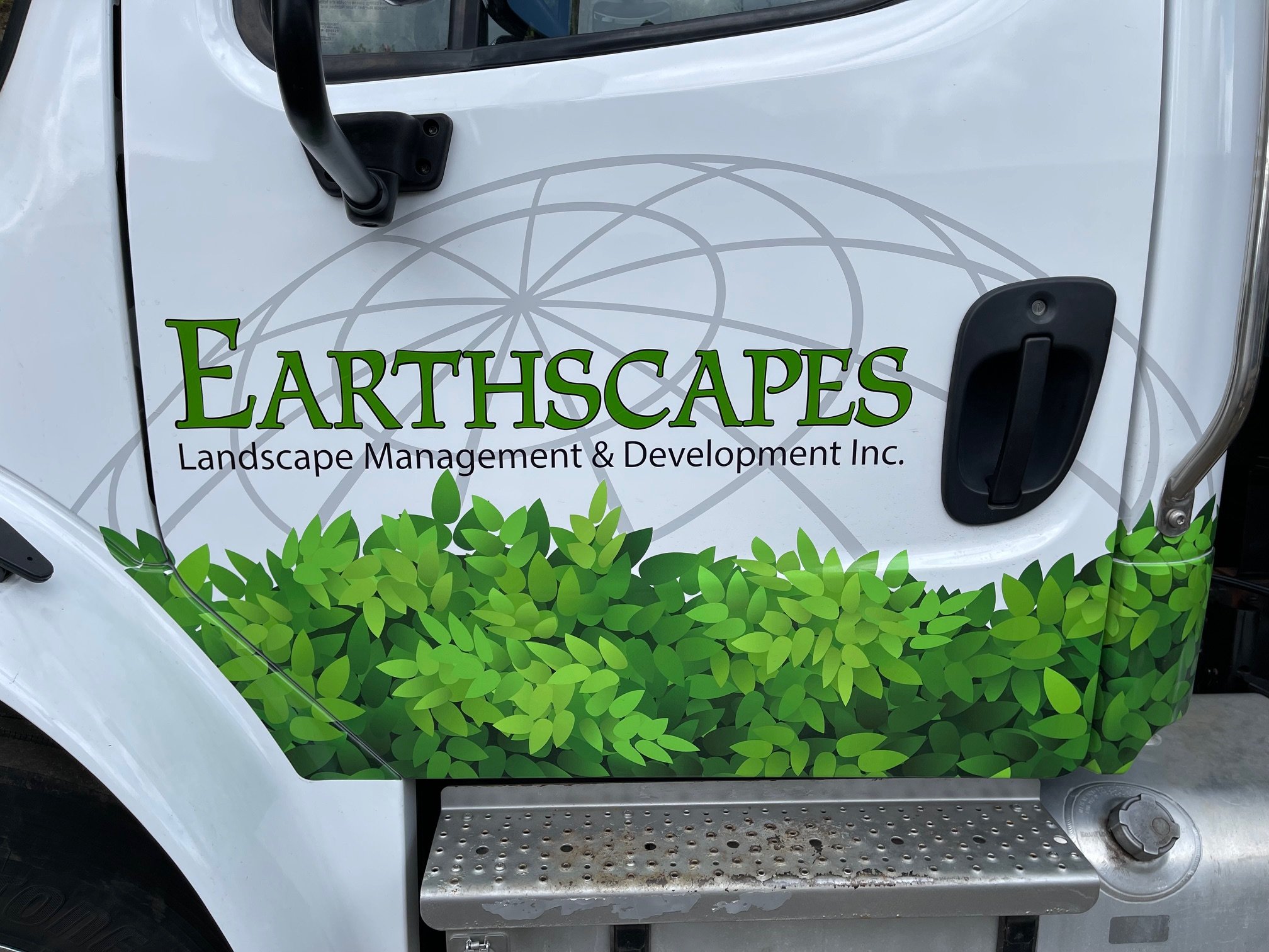 Custom wrapped foliage graphics and 3 layers using green, black and gray 