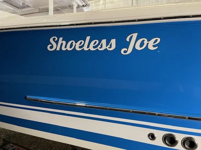White lettering with dark blue outline - for a Captain who preferred flip flops to shoes