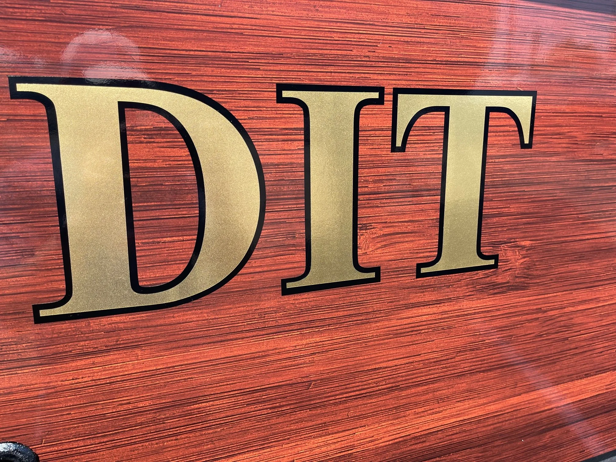 Mahogany Vinyl Wrap transom with 22K Real Gold brand lettering with Black outline