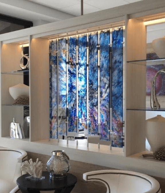 Decorative wall panel with vertical metal rods and a blue and purple abstract background in a modern living room.