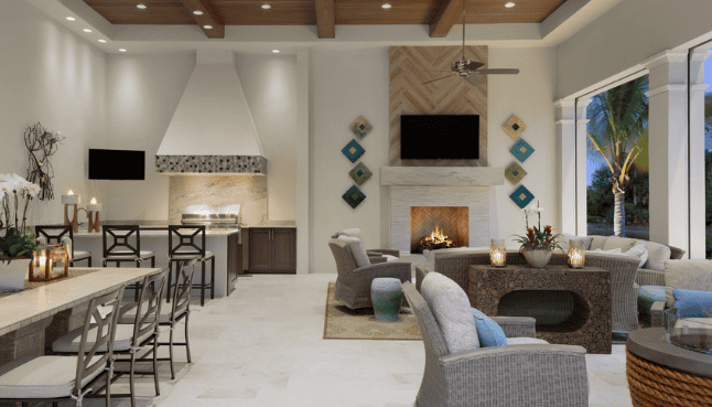 Open-concept living room and kitchen with modern decor, sofa seating around a fireplace, and a view of palm trees through large windows.