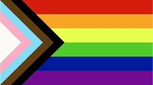 A pride flag with horizontal rainbow stripes and a chevron pattern on the left side.