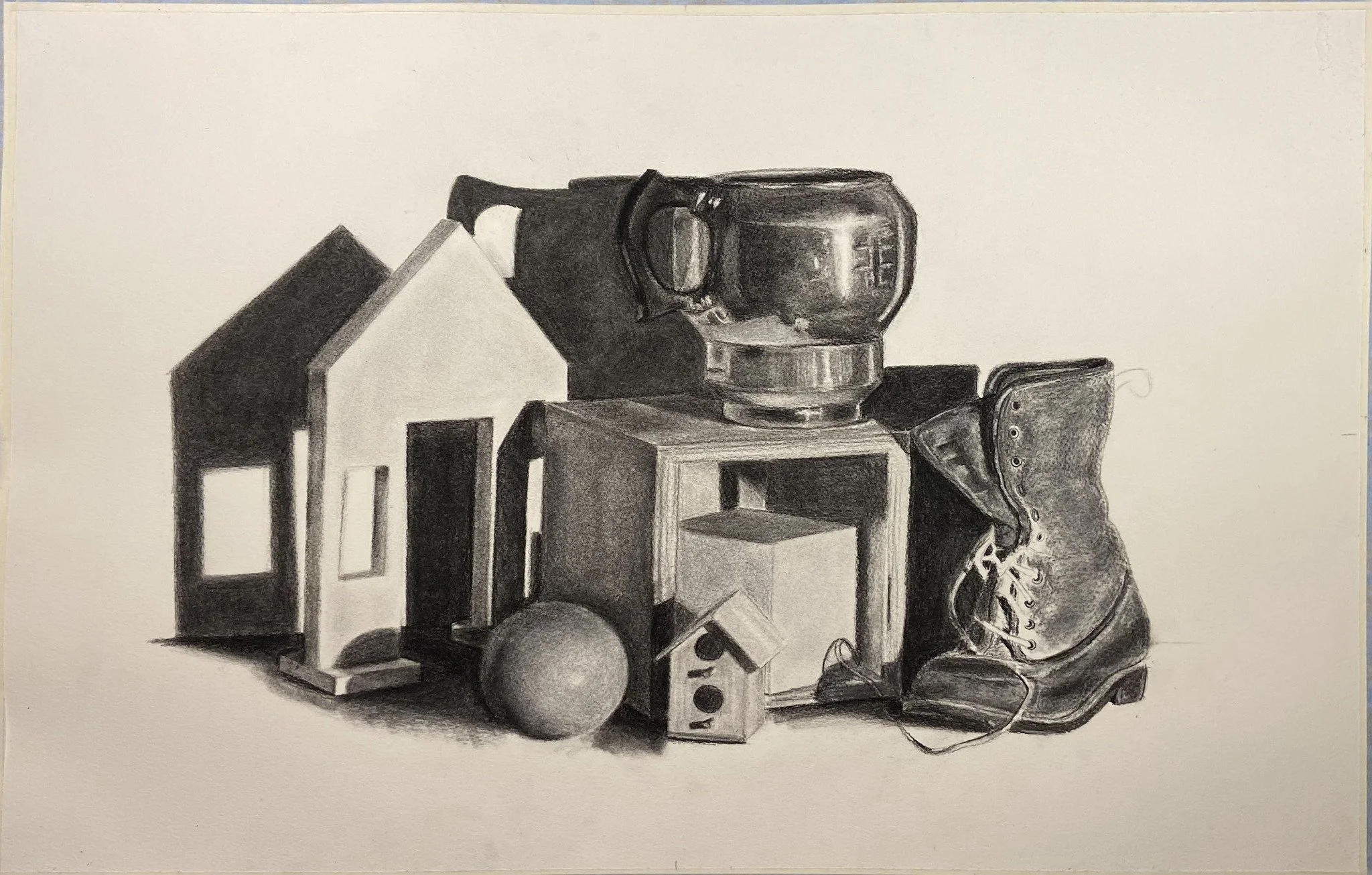 A black and white drawing featuring a collection of various objects, including a coffee mug, a sneaker, a small house, a ball, and a few geometric shapes, arranged in an artistic still life composition.