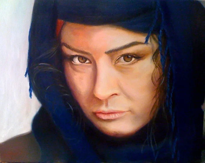 Close-up of a woman's face with dark hair and intense expression, wearing a black headscarf or hood.