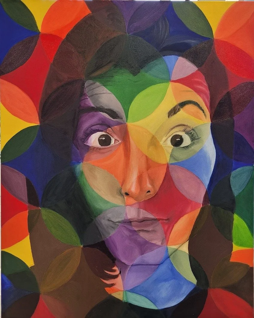 Colorful abstract artwork of a woman's face with large expressive eyes, surrounded by overlapping multicolored circles.